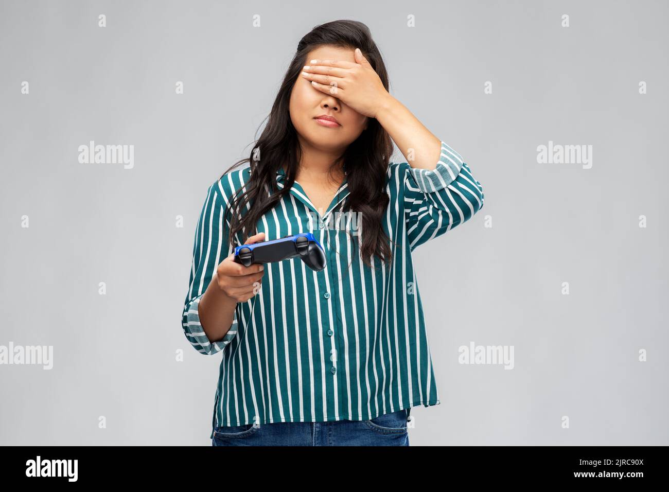 upset asian woman playing video game with gamepad Stock Photo