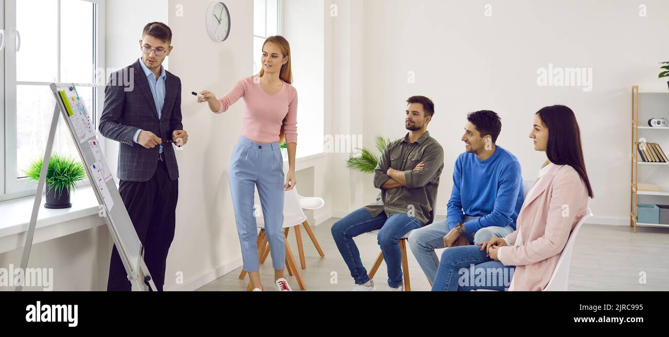 Young business people working together on new project while sitting in creative office Stock Photo