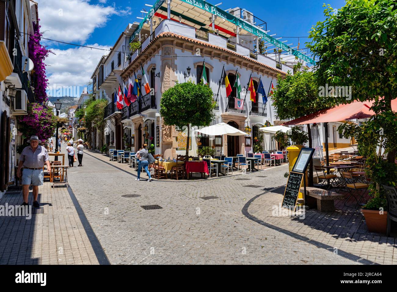 The beautiful streets with restaurants in Malaga, Spain, in sunny weather Stock Photo