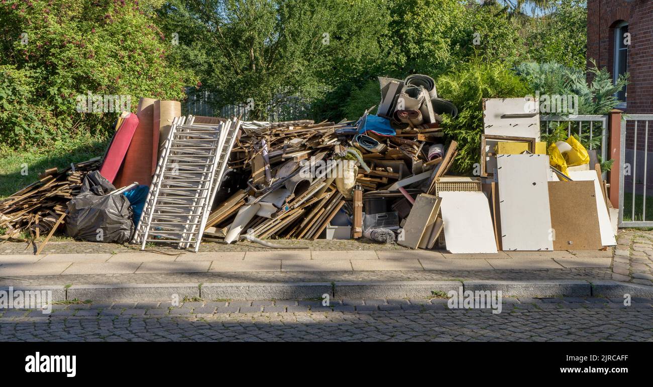 Bulky garbage heap at the roadside with furniture Stock Photo