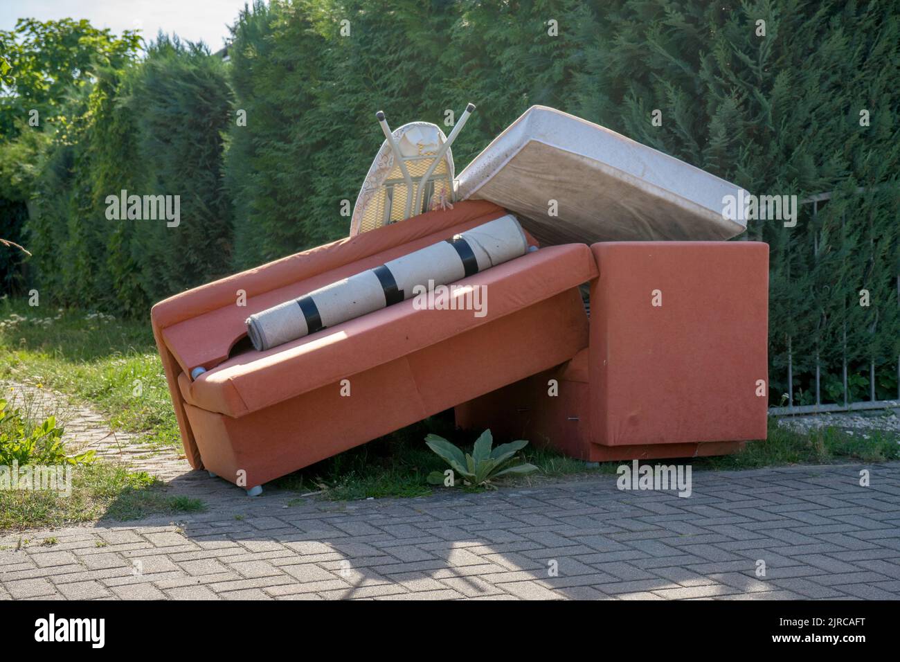 Bulky garbage heap at the roadside with upholstered furniture Stock Photo