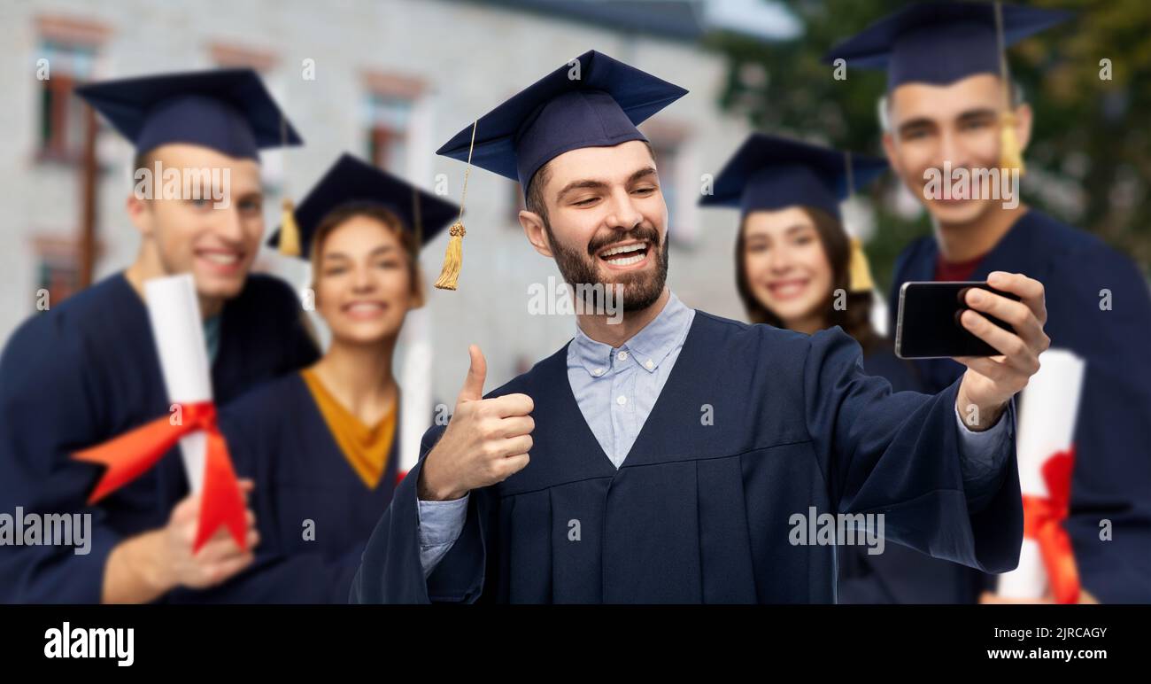 graduate students with smartphone taking selfie Stock Photo