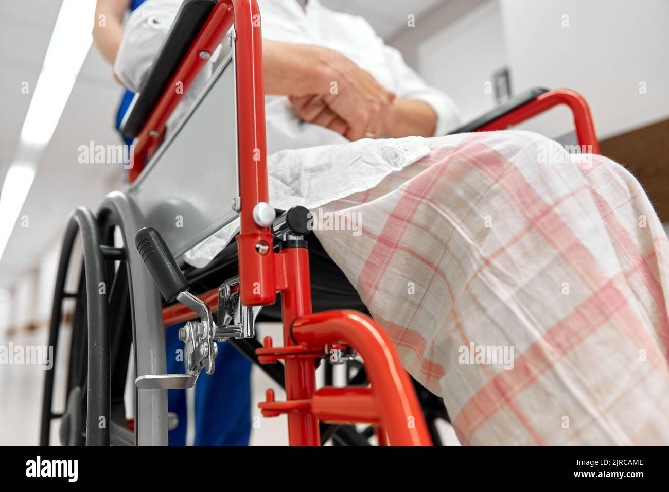 nurse with senior patient in wheelchair at clinic Stock Photo Alamy