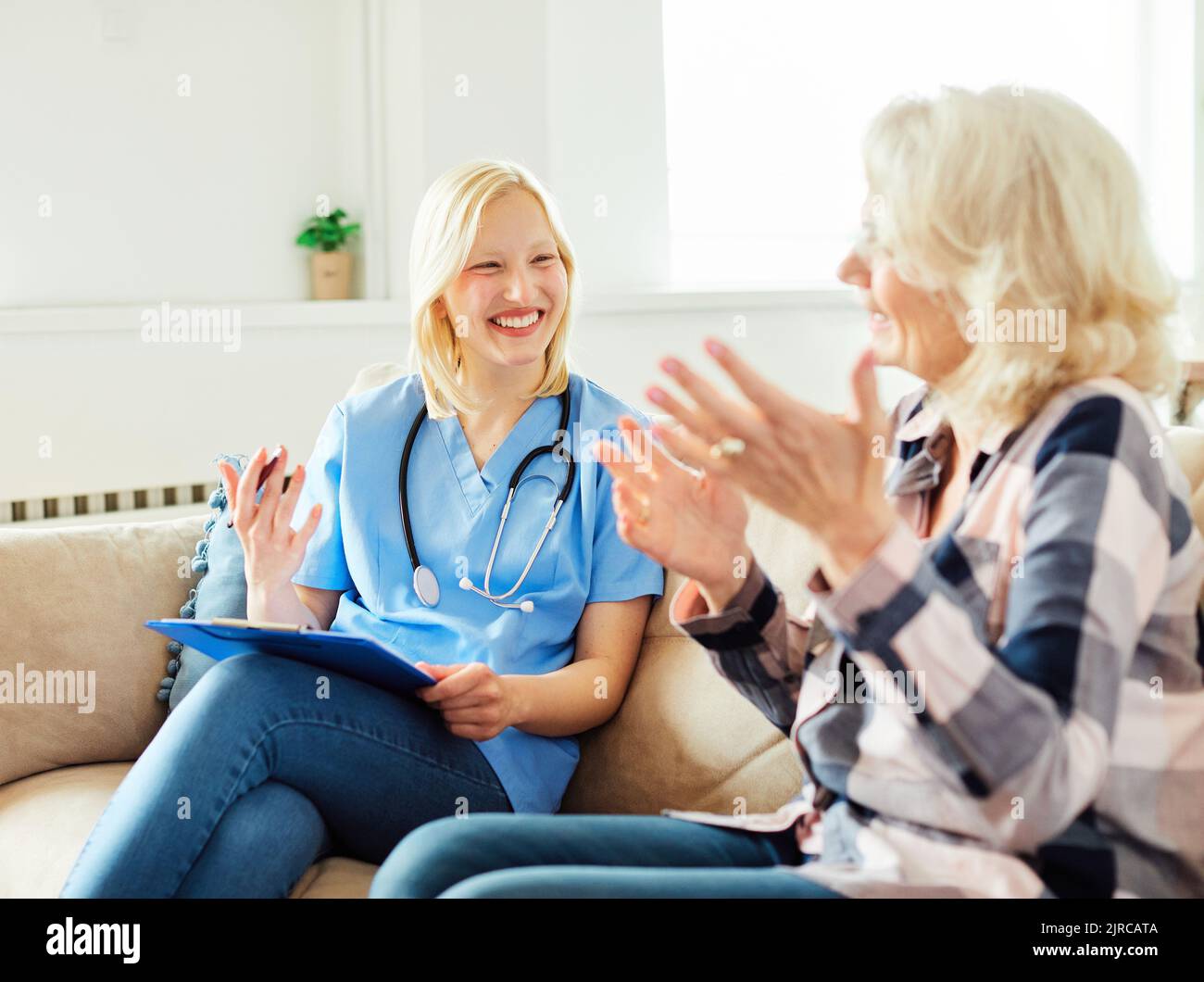 nurse doctor senior care caregiver help assistence retirement home nursing elderly woman health support Stock Photo