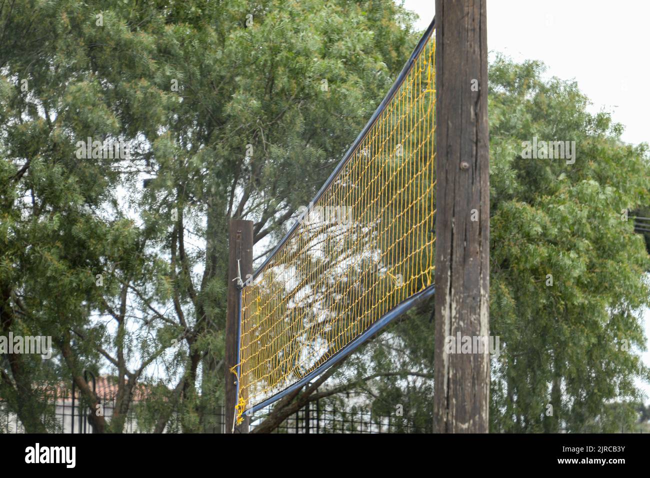 Yellow volleyball net installed in a public place, with a bottomup