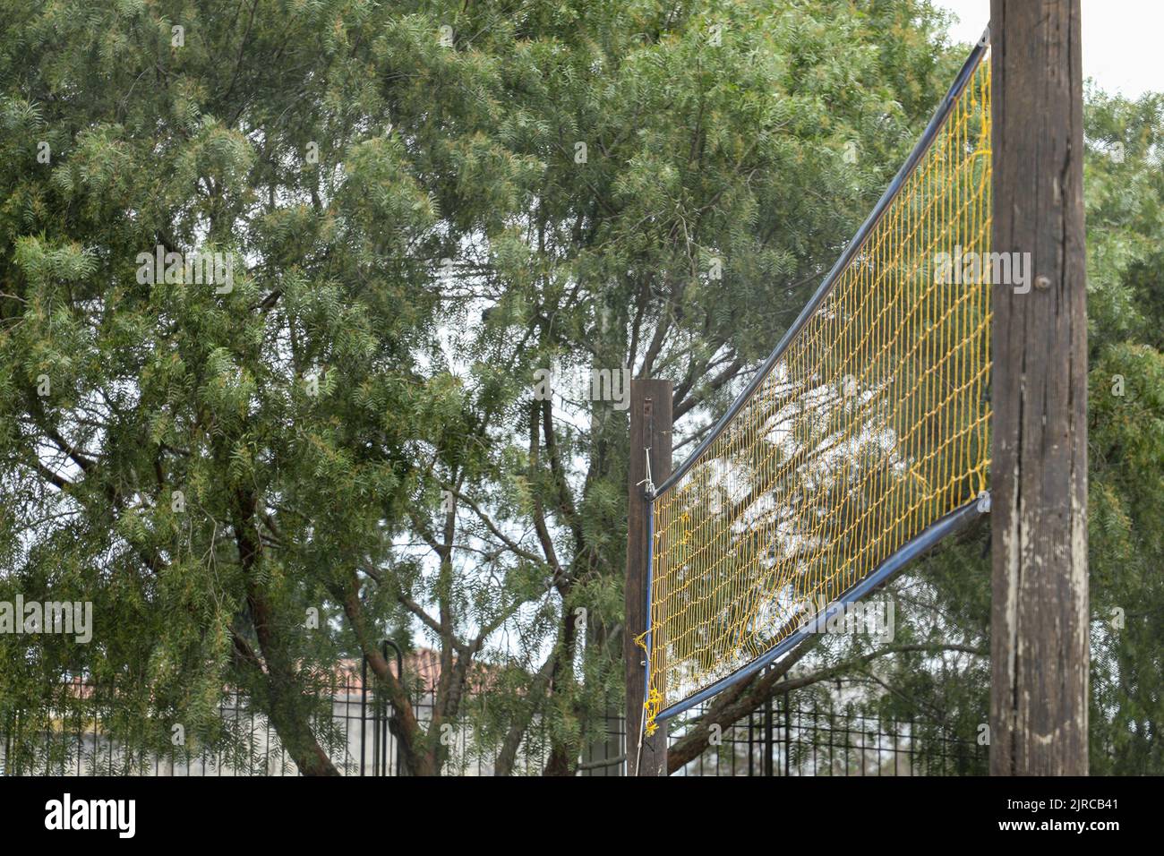 Yellow volleyball net installed in a public place, with a bottomup