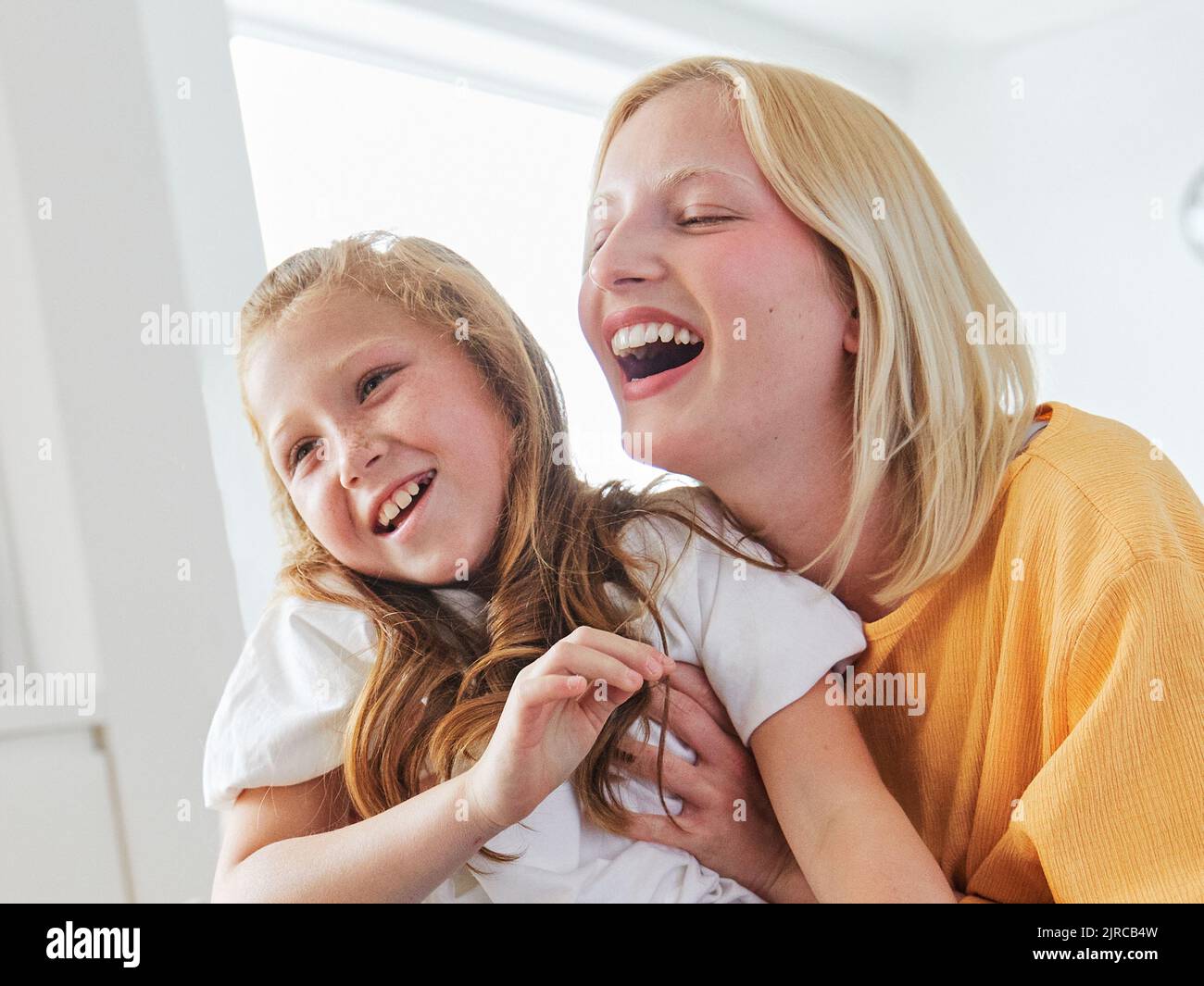 child sister fun family girl together childhood female happy daughter young lifestyle home indoor happiness kid togetherness mother woman Stock Photo