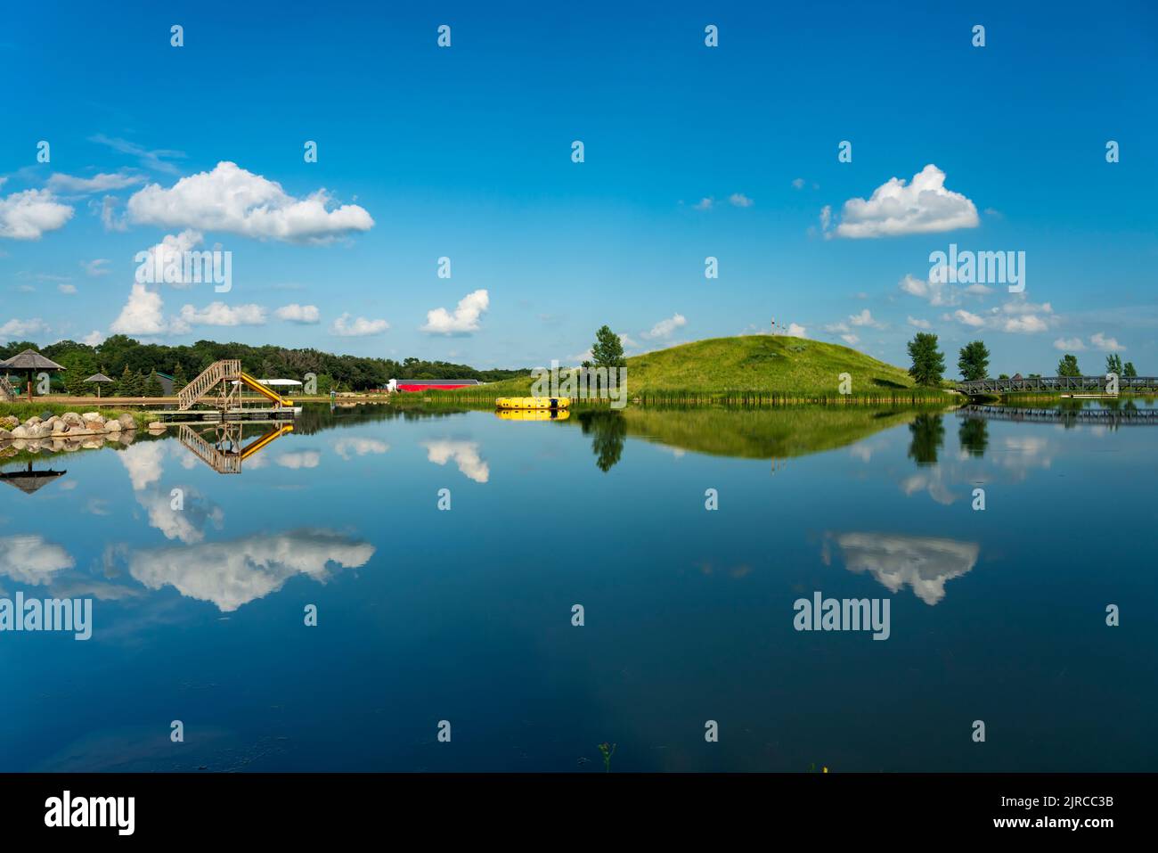 A calm lake with reflections at the Winkler Bible Camp, Winkler, Manitoba, Canada Stock Photo