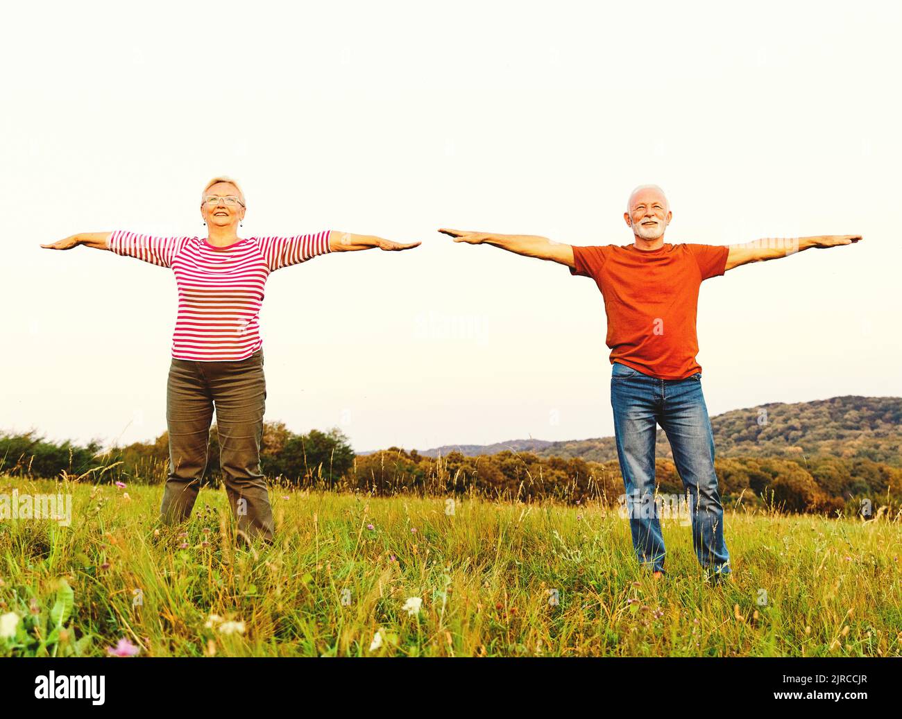 outdoor senior fitness woman man lifestyle active sport exercise healthy fit retirement stretching elderly couple Stock Photo