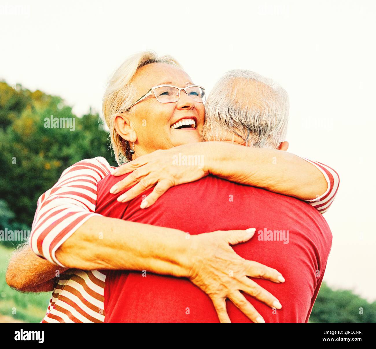 woman man outdoor senior couple happy lifestyle retirement together smiling love hug nature mature Stock Photo