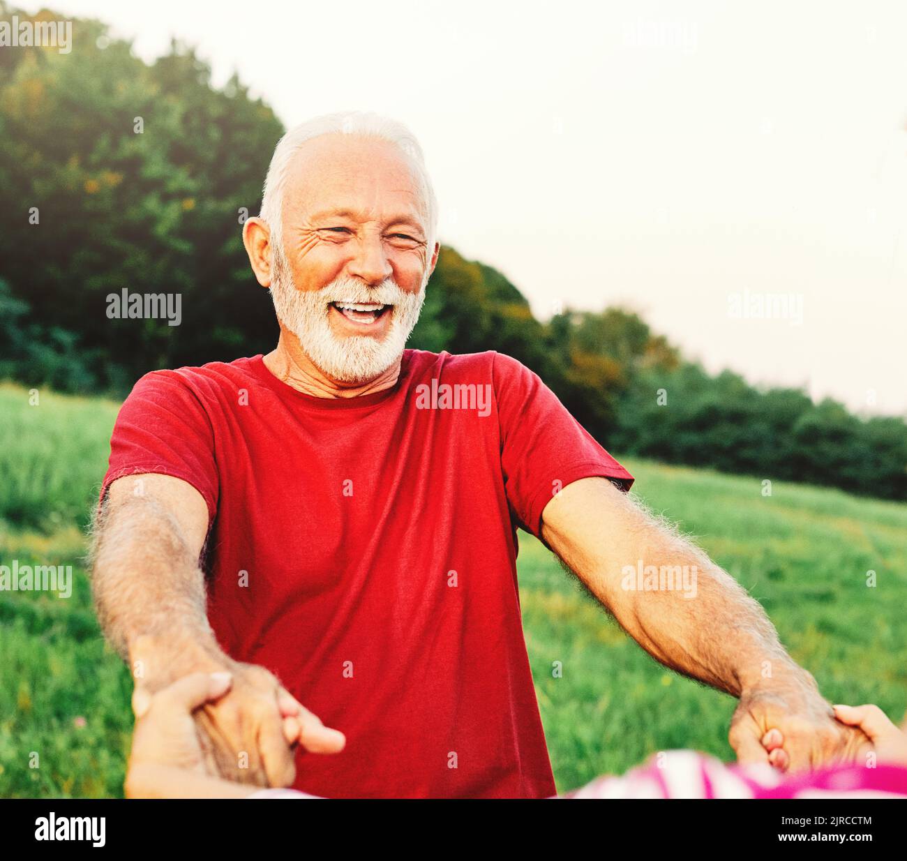woman man outdoor senior couple happy lifestyle retirement together smiling love dancing fun playing game active vitality nature mature Stock Photo