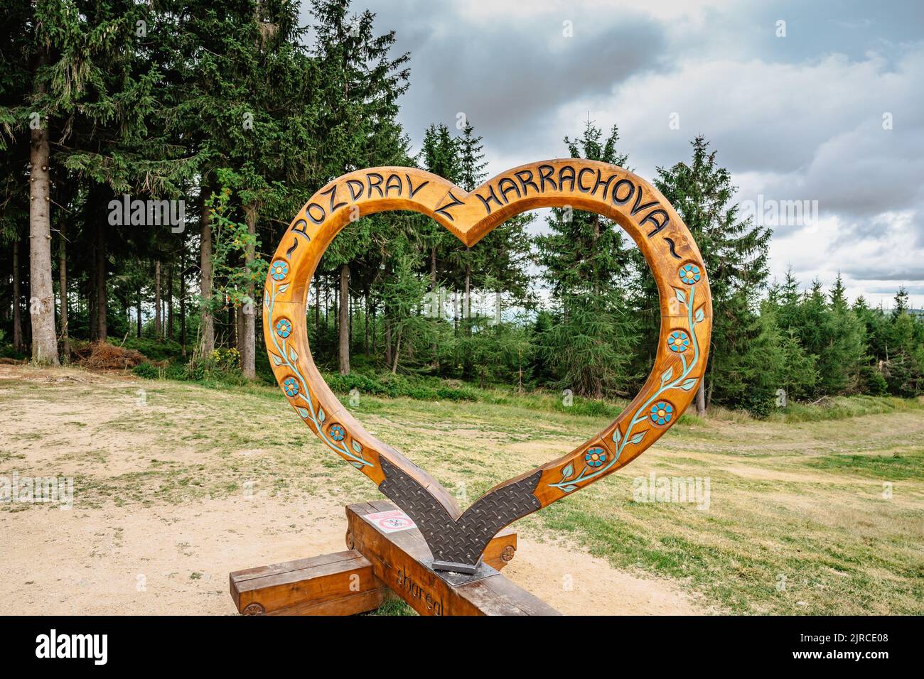 Harrachov,Czech Republic-August 13,2022. Photo frame with wooden heart and sign Hello from Harrachov.Certova hora,Krkonose mountains. Popular tourist Stock Photo