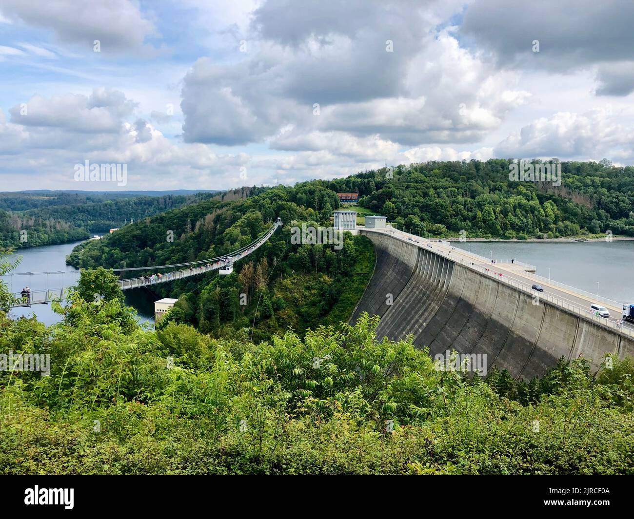 A beautiful view of the highest dam in Germany Rappbode Dam with a bridge and river down below surrounded by greenery Stock Photo