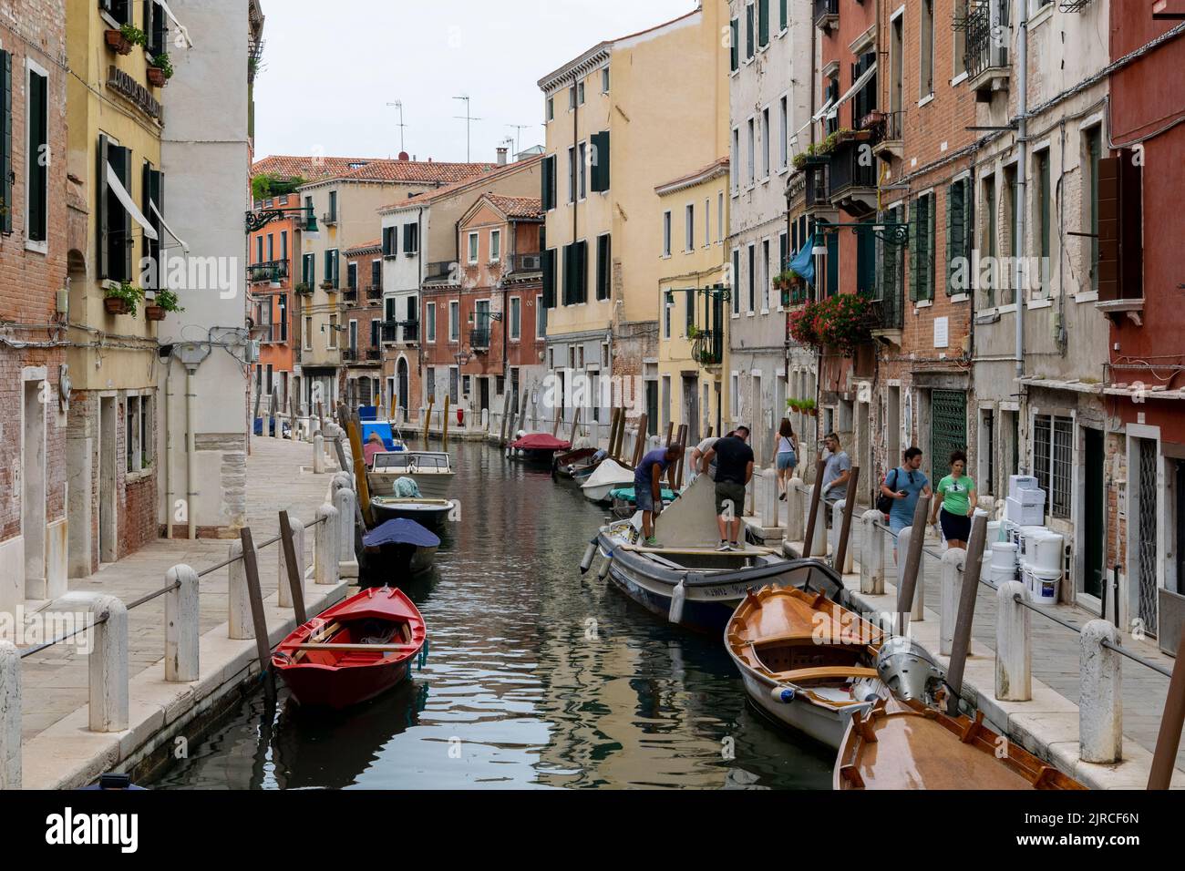 Boats parked at a water channel in Venice, Italy Stock Photo