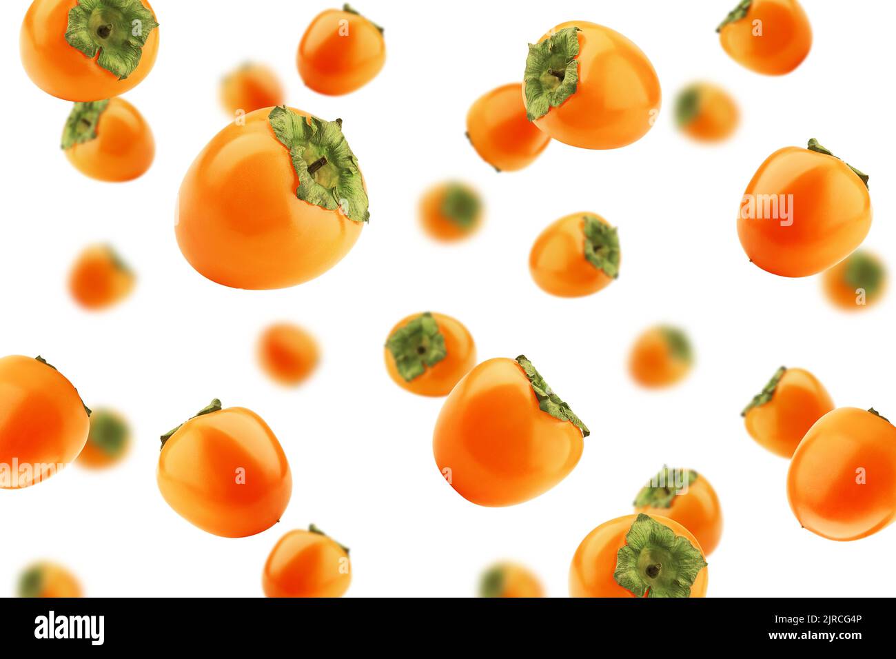 Falling persimmon isolated on white background, selective focus Stock Photo
