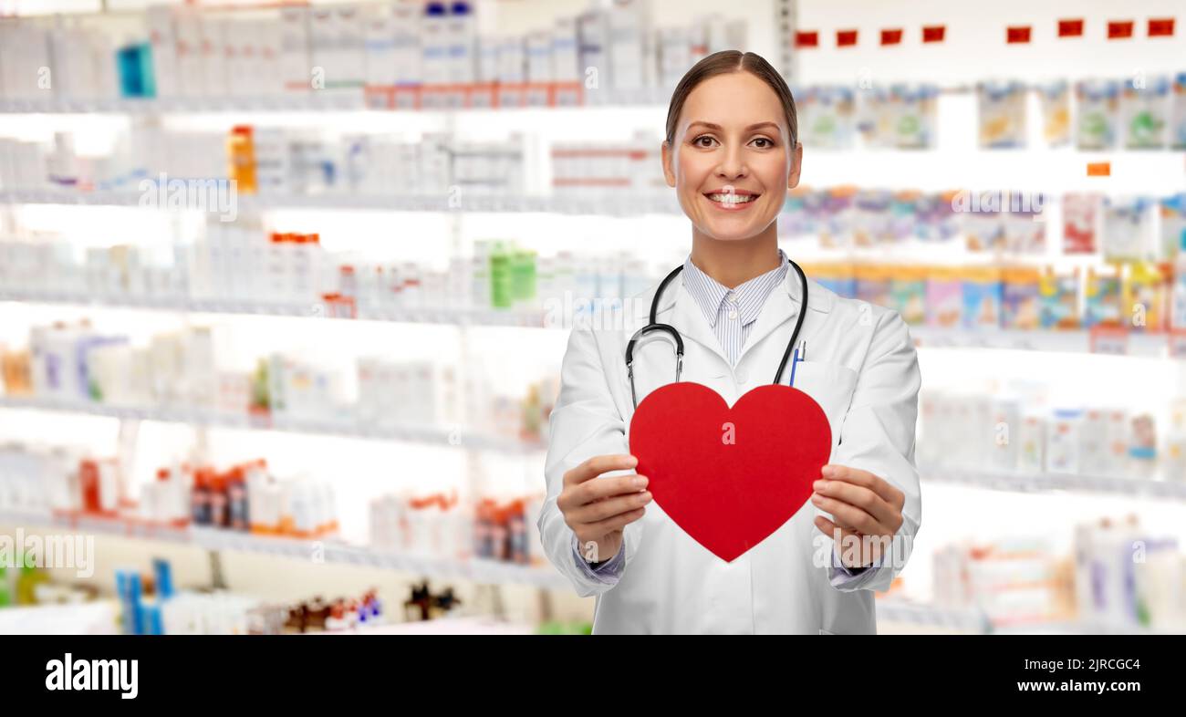 smiling female doctor with heart and stethoscope Stock Photo - Alamy