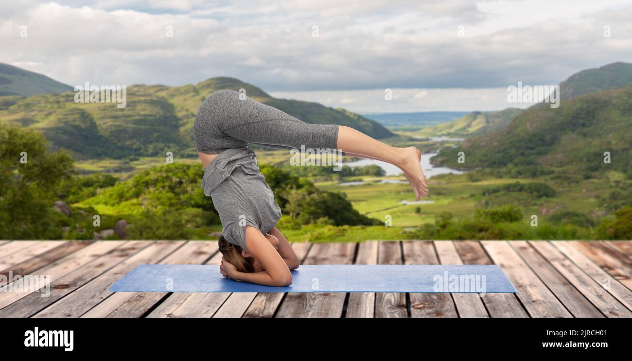 woman doing yoga over Killarney National Park Stock Photo