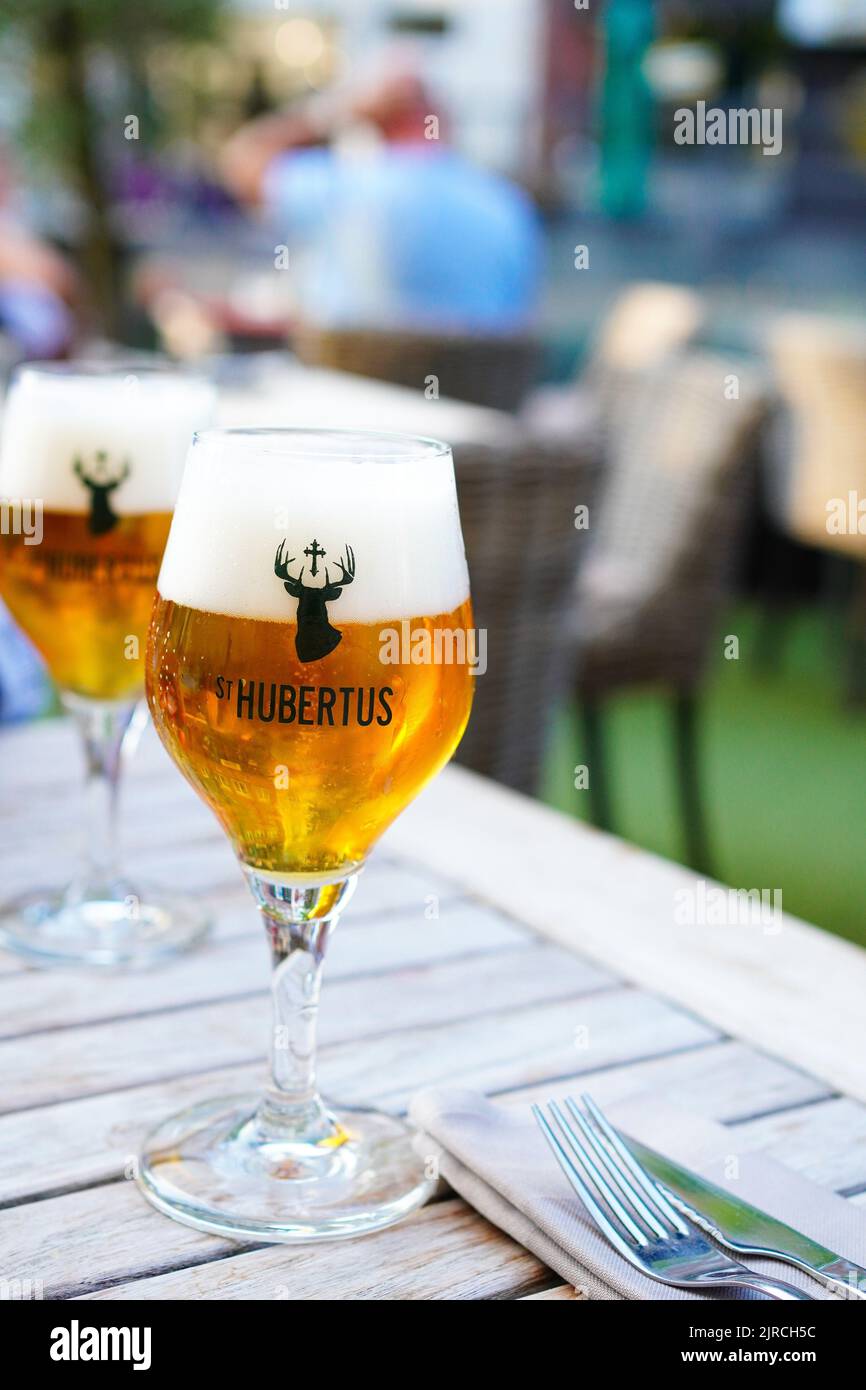 Belgian beer St.HUBERTUS (Sint Hubertus ) in a restaurant on a Belgian summer night sint-niklaas belgium Stock Photo