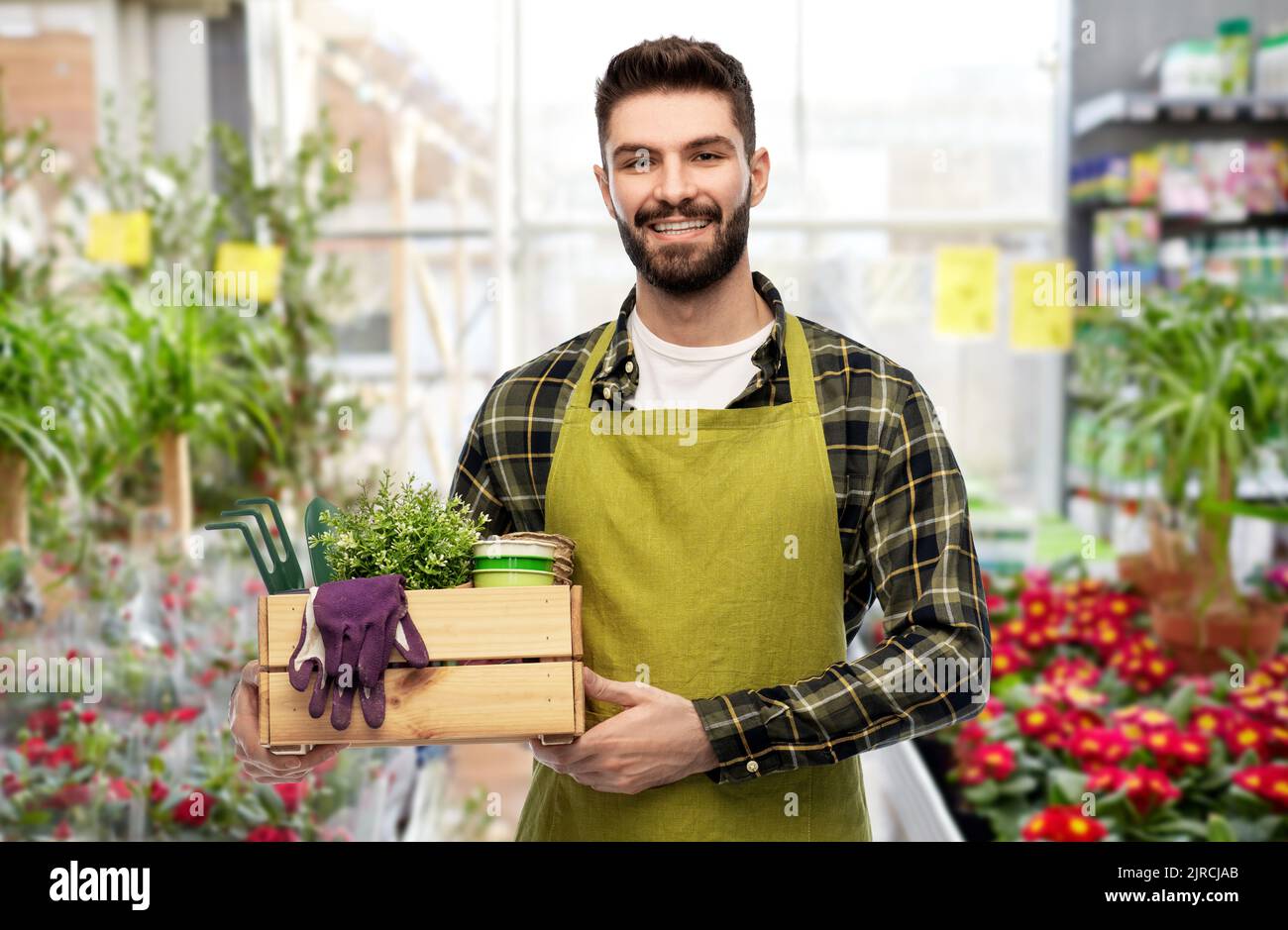 happy gardener or seller with box of garden tools Stock Photo - Alamy