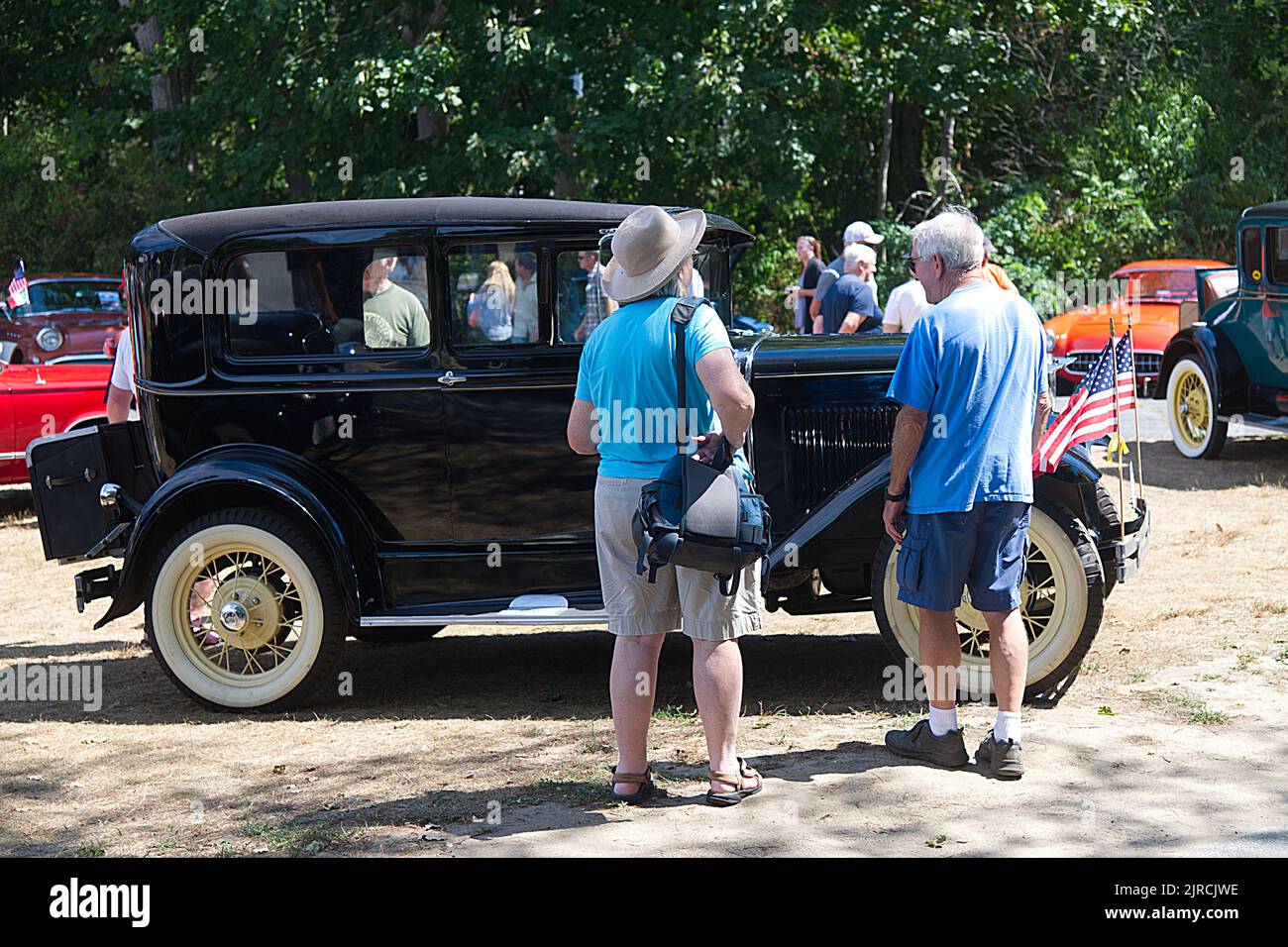 Looking over a restored antique Ford at an antique auto parade and show in Dennis, Massachusetts, Cape Cod, USA Stock Photo