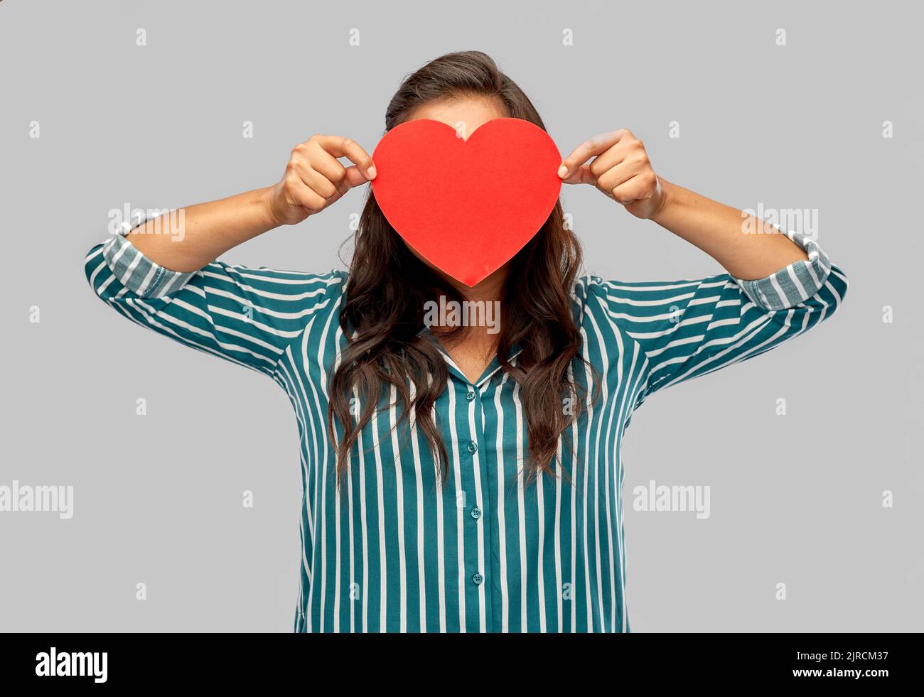 woman covering her face with red heart Stock Photo Alamy