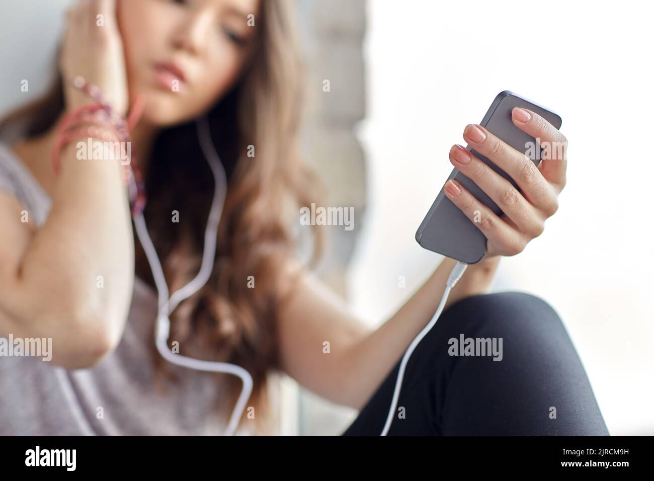 teenage girl with smartphone and earphones Stock Photo - Alamy