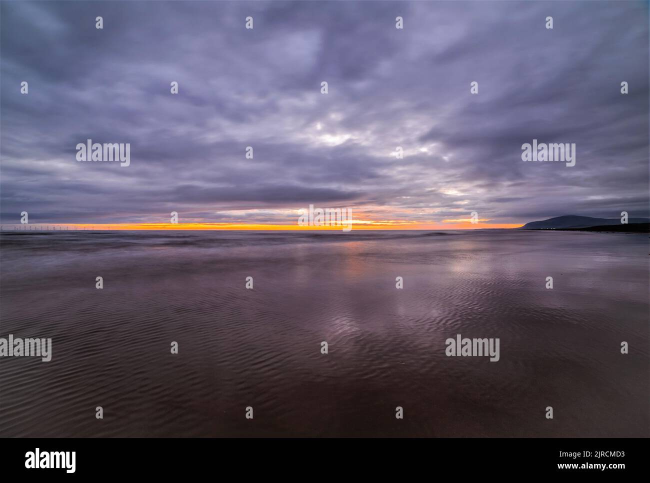 Walney Island, Cumbrian Coast UK. 23rd August 2022. UK Weather. After a warm day with sunshine and showers, sunset view towards Black Combe from Walney Island on the Cumbrian Coast. Credit:greenburn/Alamy Live News. Stock Photo