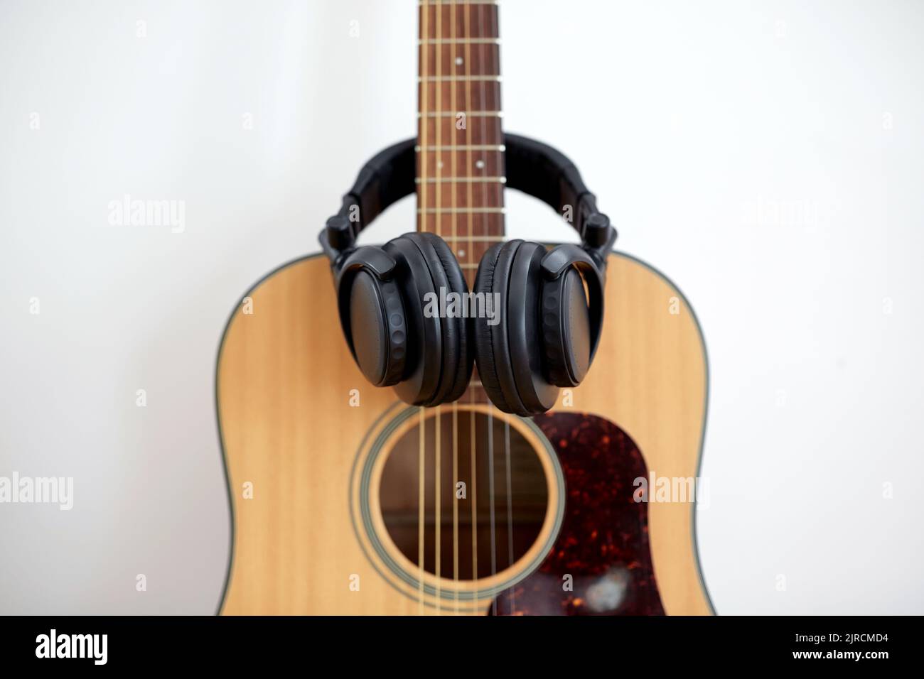close up of acoustic guitar and headphones Stock Photo