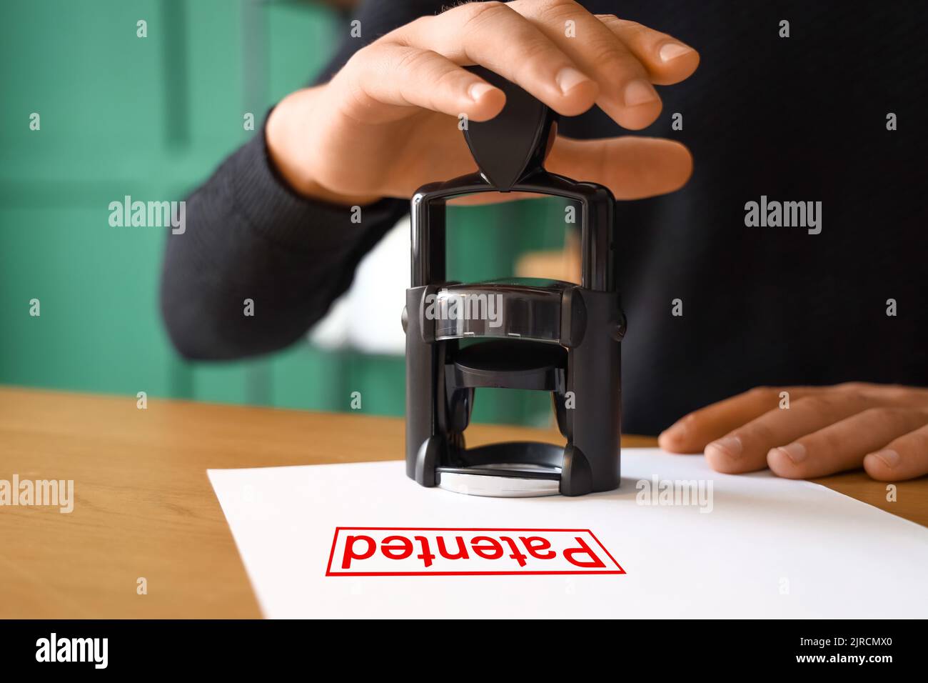 Male notary public notarizing right to the patent in office, closeup ...