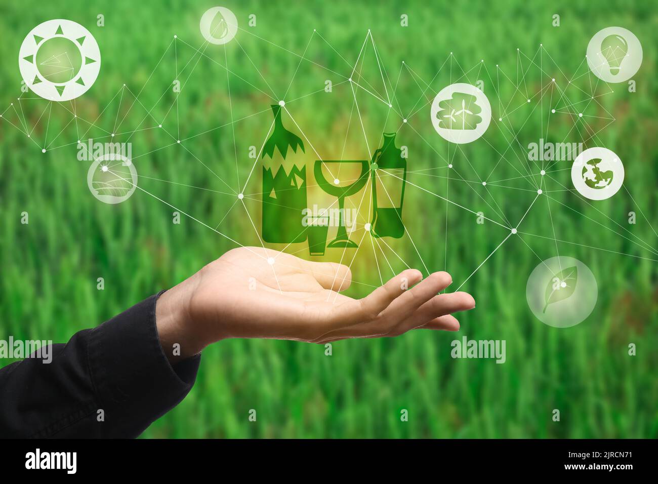 Male hand with digital icons and drawing of garbage on blurred green ...