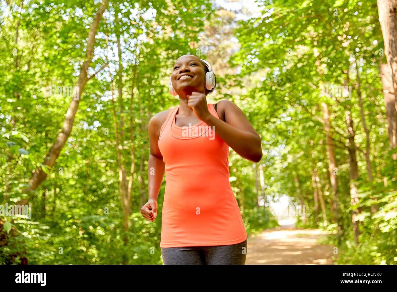 Black woman running headphones hi-res stock photography and images - Alamy