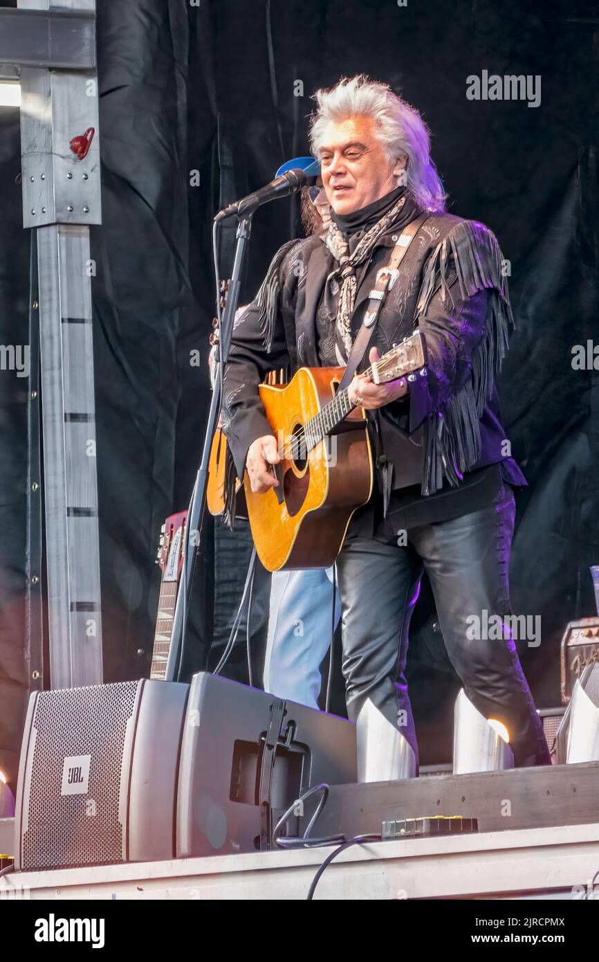 Marty Stuart performing live in an outdoor concert, part of An