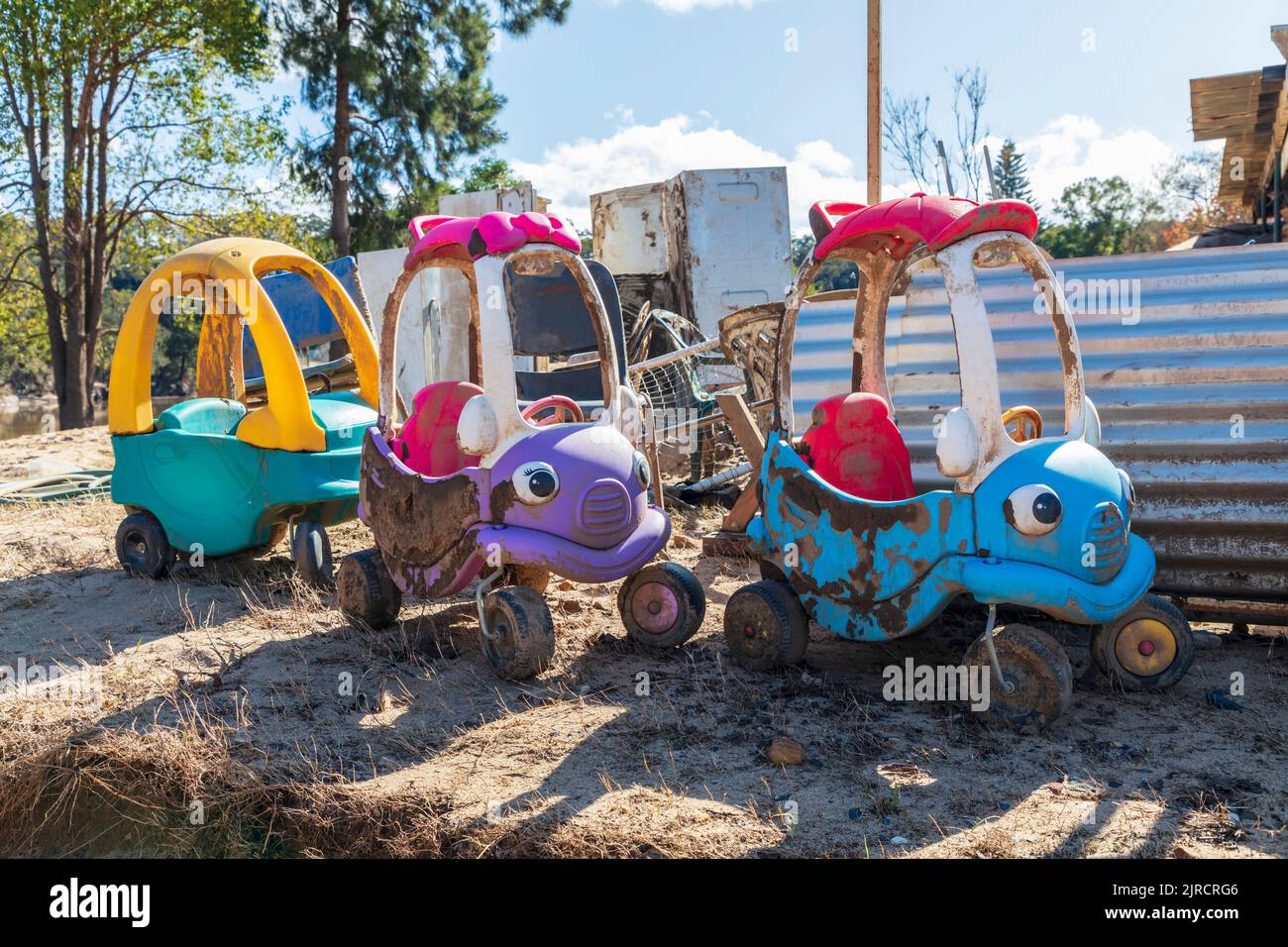 Photograph of children’s toys covered in mud caused by severe flooding