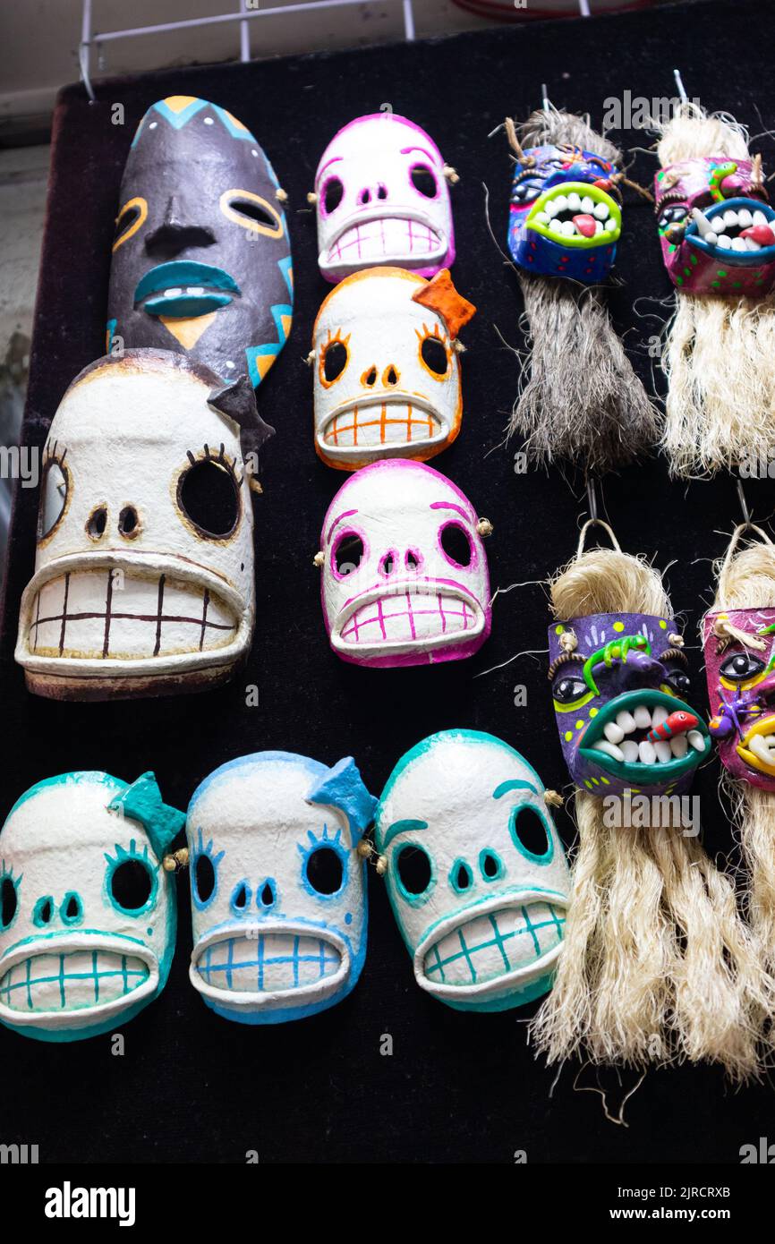 colorful mexican tiki style day of the dead bearded skull mask of carnival of oaxaca adornment for sale in a traditional market as souvenir for touris Stock Photo