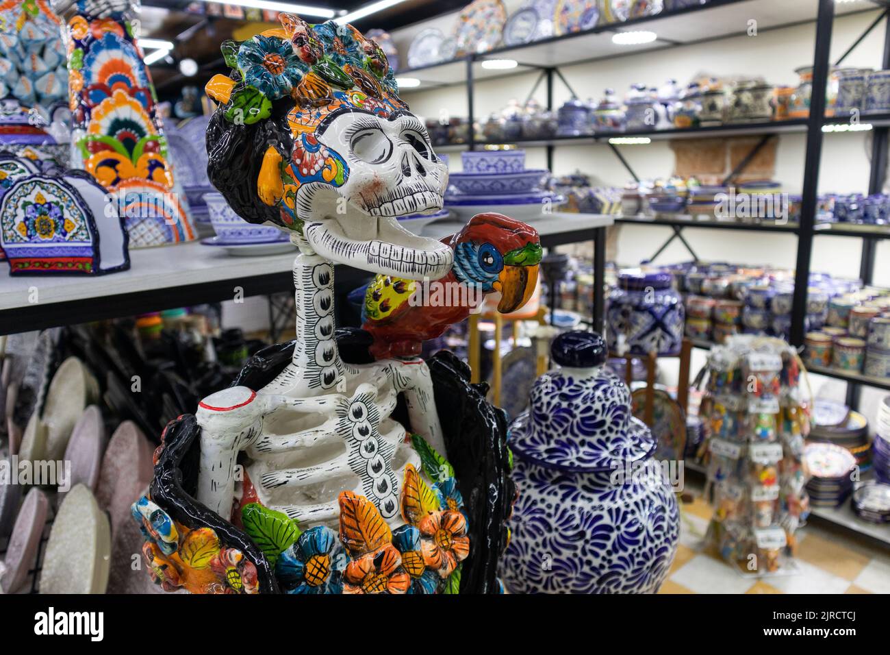 Puebla city, Puebla, Mexico - August 08 2022: pottery sculpture statue of a traditional catrina mexican day of the dead skeleton skull in a souvenir s Stock Photo