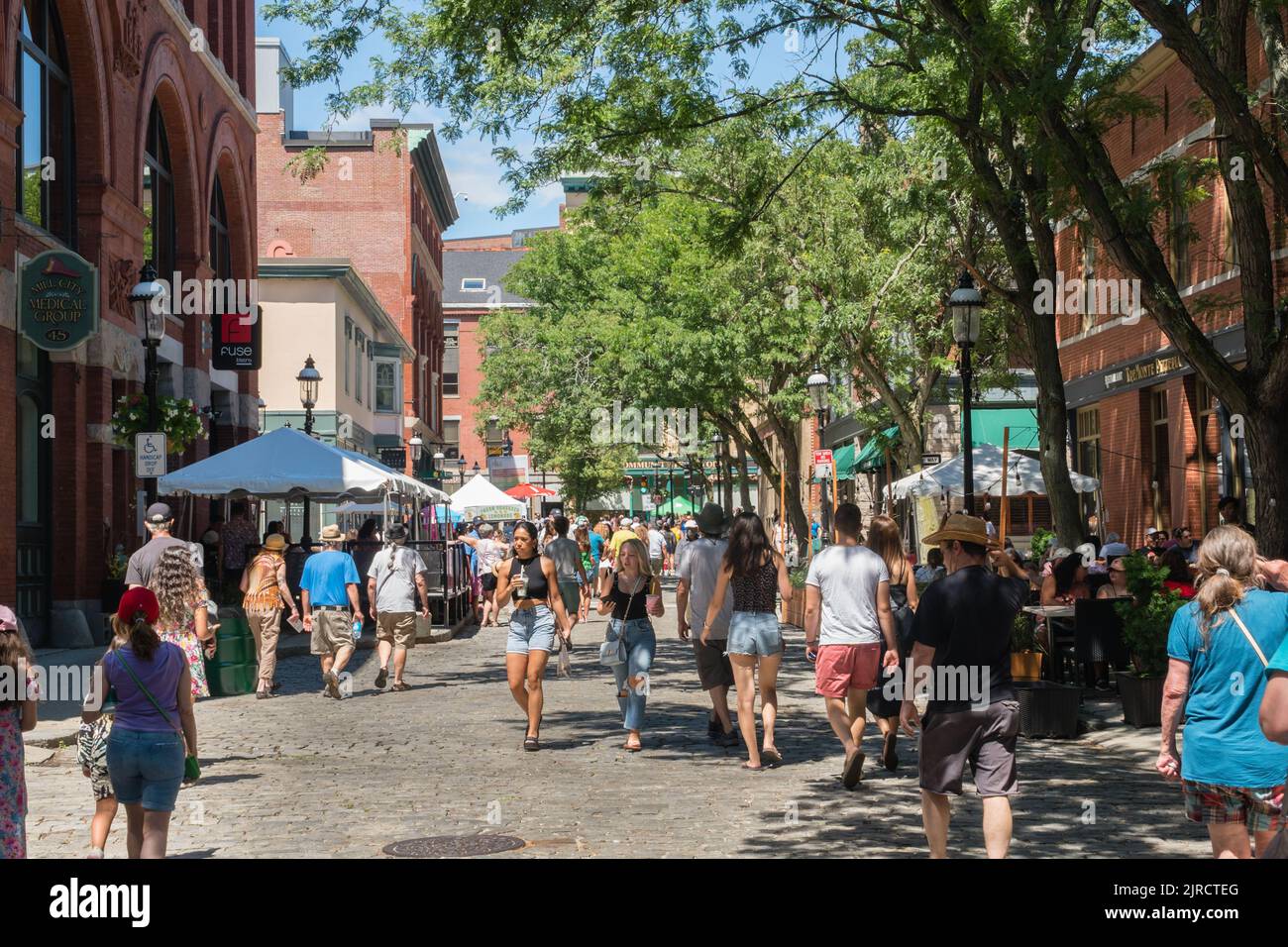 Lowell, Massachusetts, US-July 30, 2022: People dining at outdoor restaurants at the Lowell Folk Festival is a large free outdoor music festival. Stock Photo