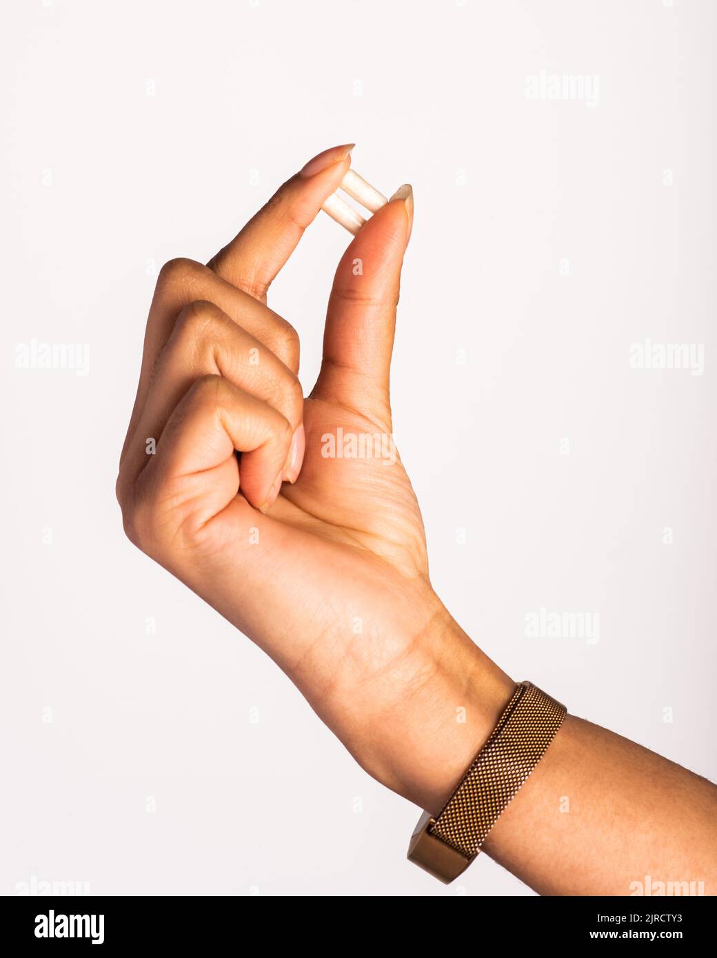 Hand holding vitamin pills, supplements Stock Photo
