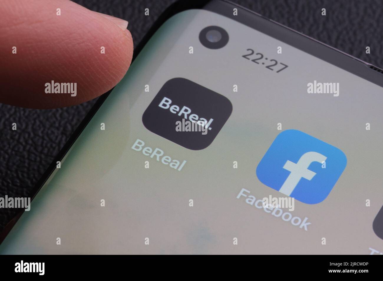 Finger touching Bereal app which is the next to Facebook app. BeReal is a new social media app and Photo sharing platform. Stafford, United Kingdom, A Stock Photo