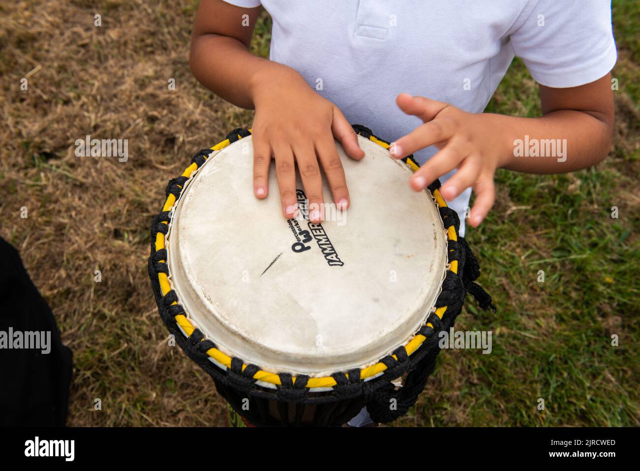 Children hand drumming in outdoor school music lesson Stock Photo Alamy