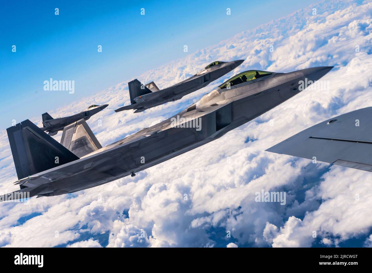 Poland. 10th Aug, 2022. Three U.S. Air Force F-22 Raptor aircraft assigned to the 90th Fighter Squadron, Joint Base Elmendorf-Richardson, Alaska, fly alongside a U.S. Air Force KC-135 Stratotanker aircraft assigned to the 100th Air Refueling Wing at Royal Air Force Mildenhall, England, over Poland, Aug. 10, 2022. The NATO Air Shielding mission provides a near seamless shield from the Baltic to Black Seas, ensuring NATO Allies are better able to safeguard and protect Alliance territory, populations and forces from air and missile threat. (Credit Image: © U.S. Air Force/ZUMA Press Wire Servi Stock Photo