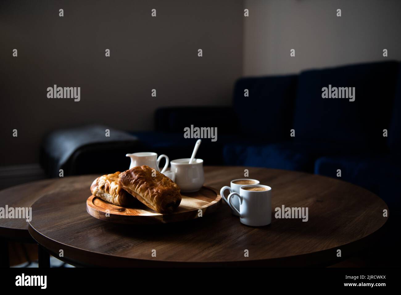 Pastries and coffee on coffee table in living room Stock Photo Alamy