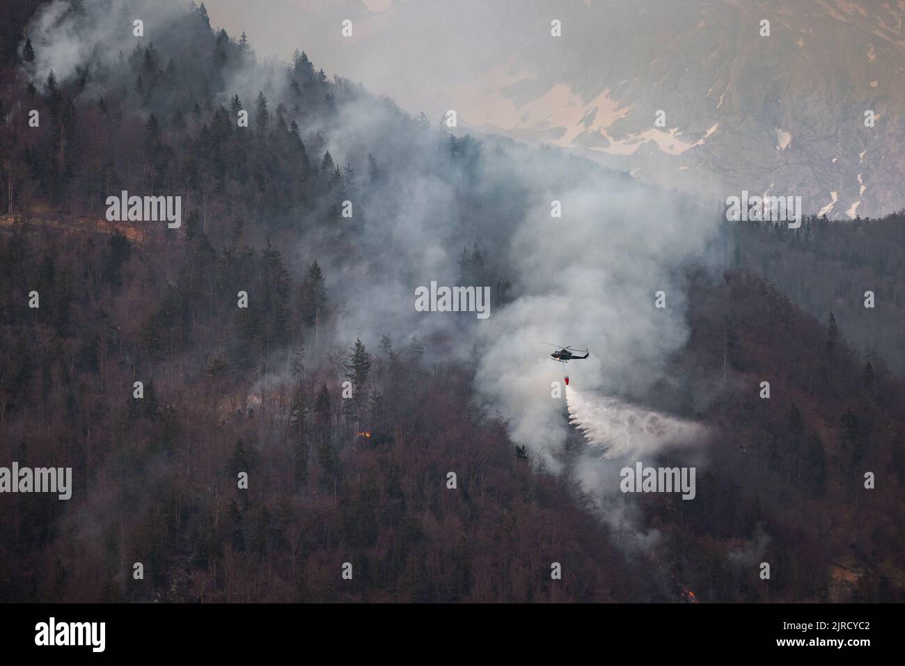 The helicopter carrying a bucket to deliver water for aerial
