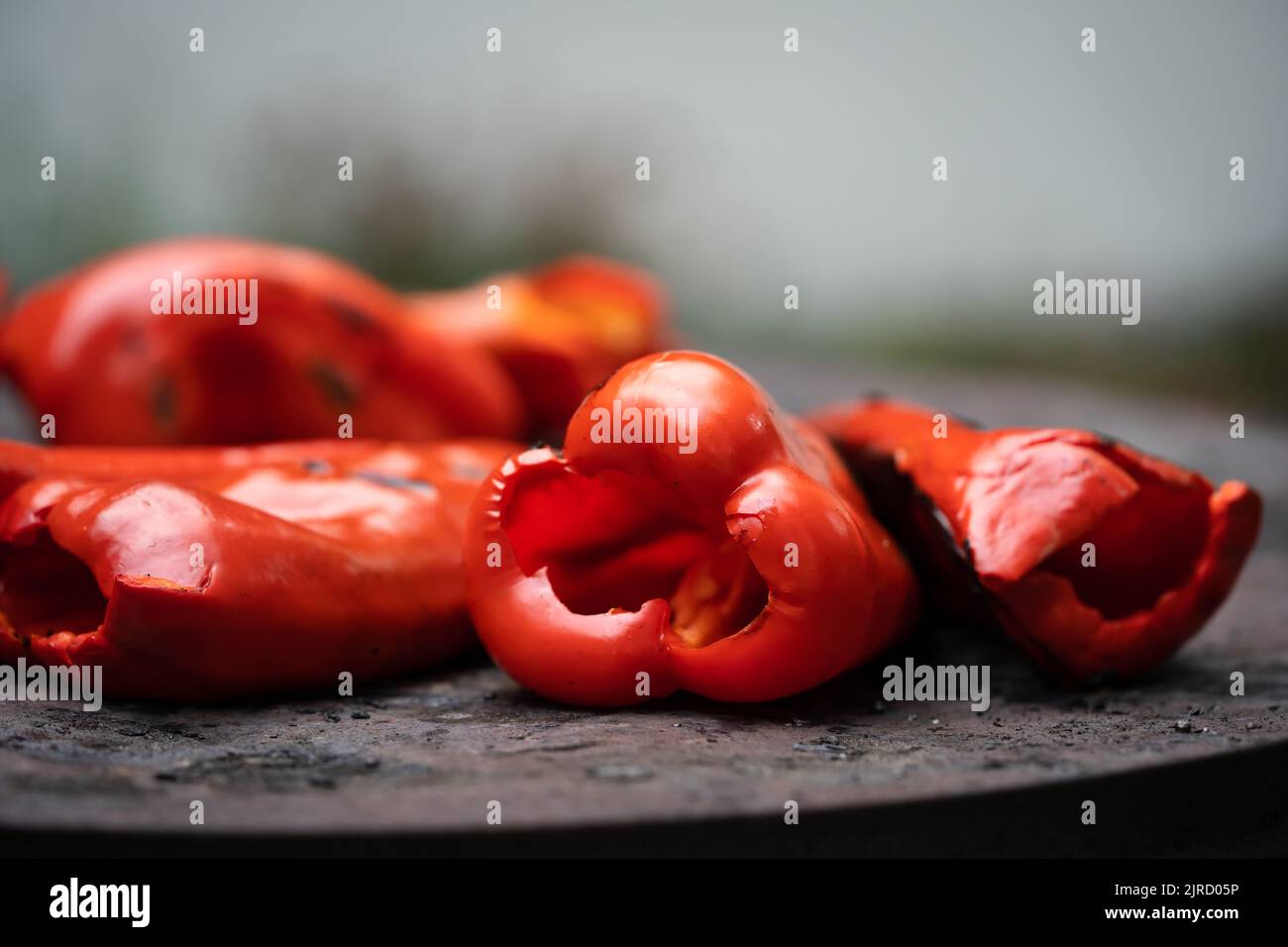 roasting paprika for winter provisions red organic peppers on the stove