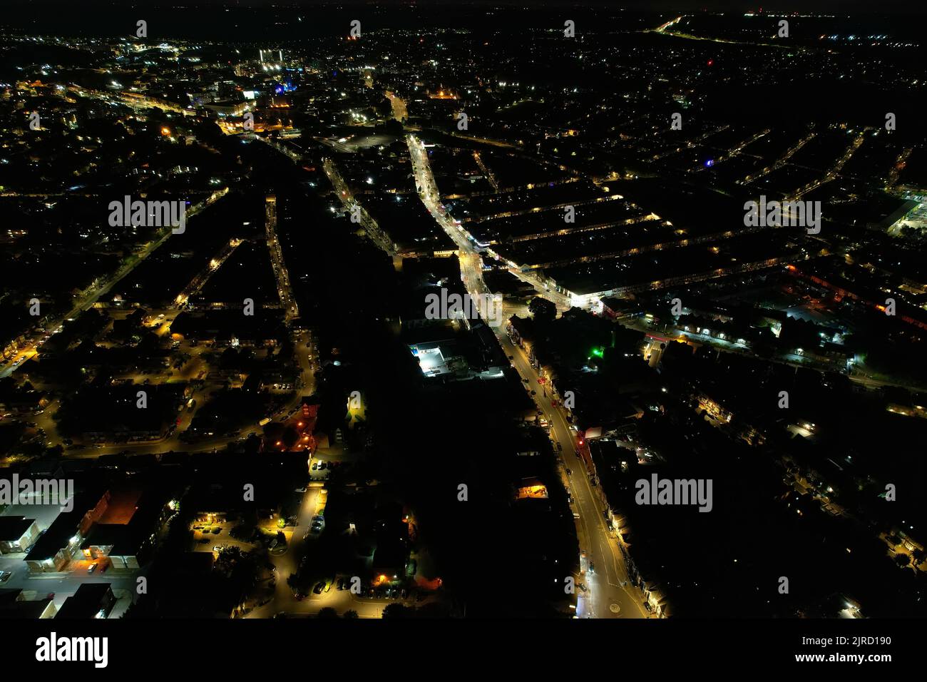 Aerial View Footage of British Houses, Illuminated Roads with Traffic on Motorways at England. High Angle Footage of British British City at Night. Stock Photo