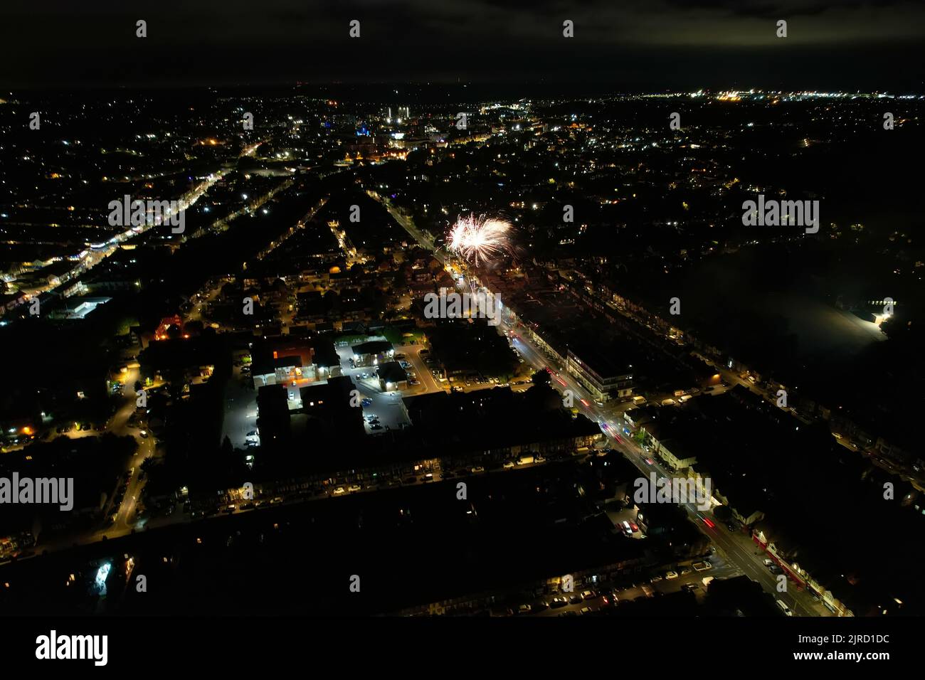 Aerial View Footage of British Houses, Illuminated Roads with Traffic on Motorways at England. High Angle Footage of British British City at Night. Stock Photo