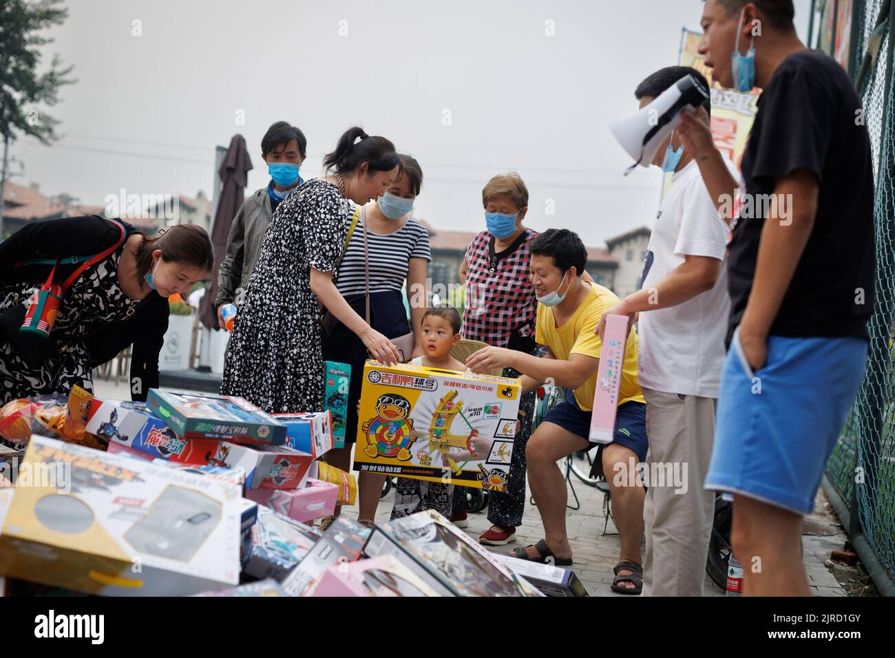 People look at toys that are for sale at a car boot fair in Beijing, China, August 13, 2022.   REUTERS/Thomas Peter Stock Photo