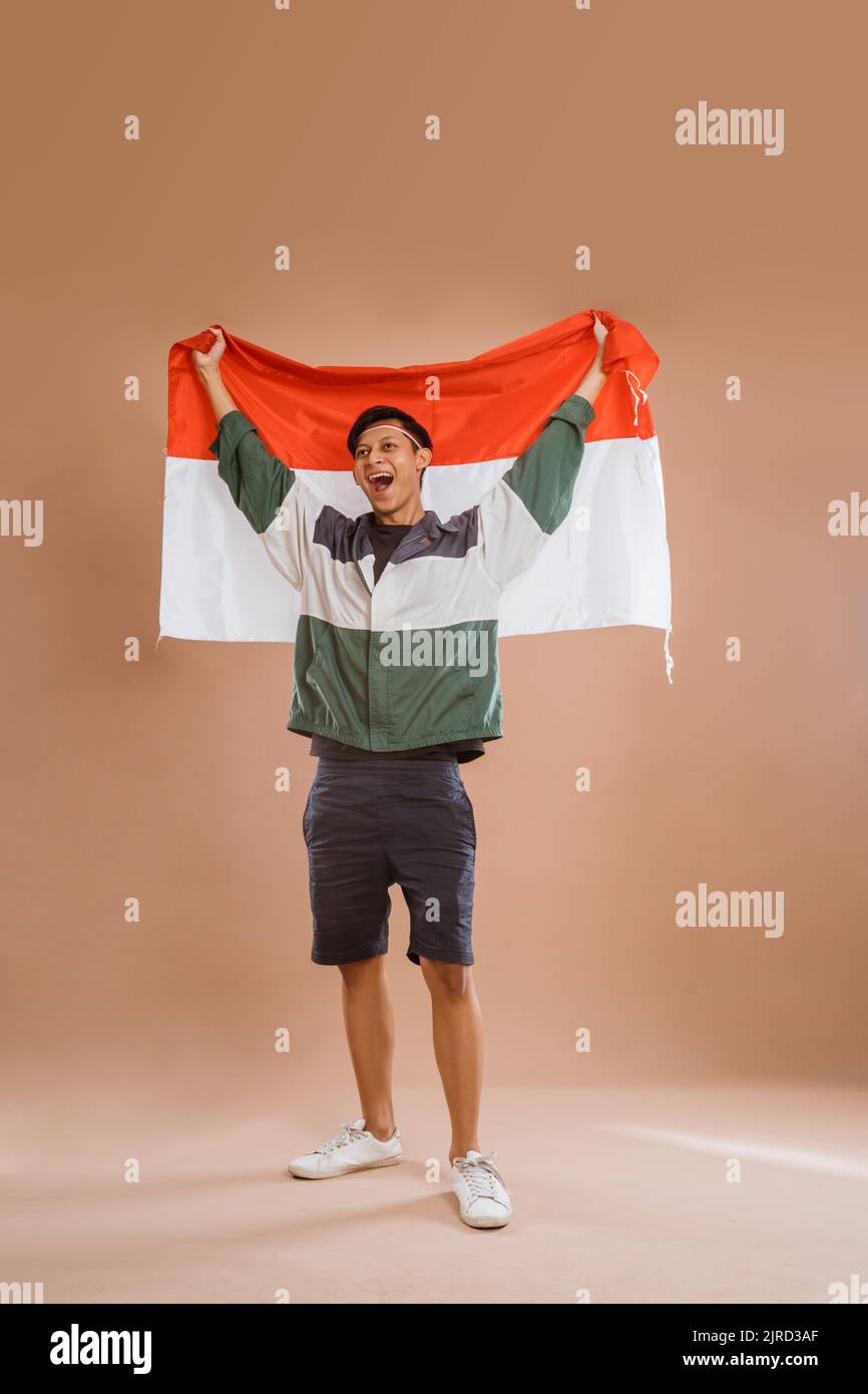male athelete from indonesia holding indonesian flag proudly Stock Photo