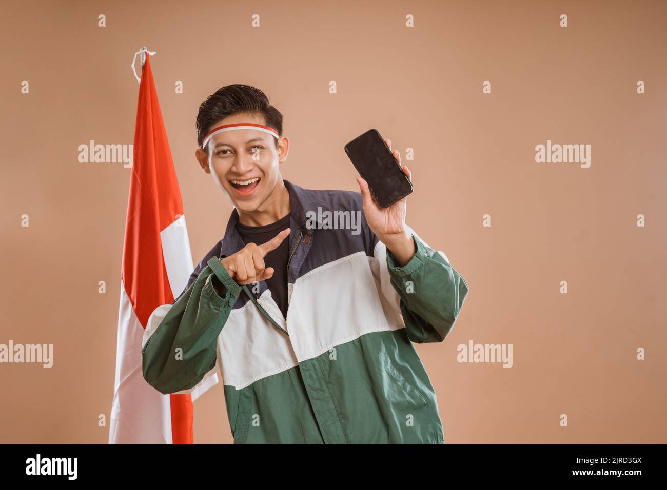 young male athelete using mobile phone over isolated background Stock Photo