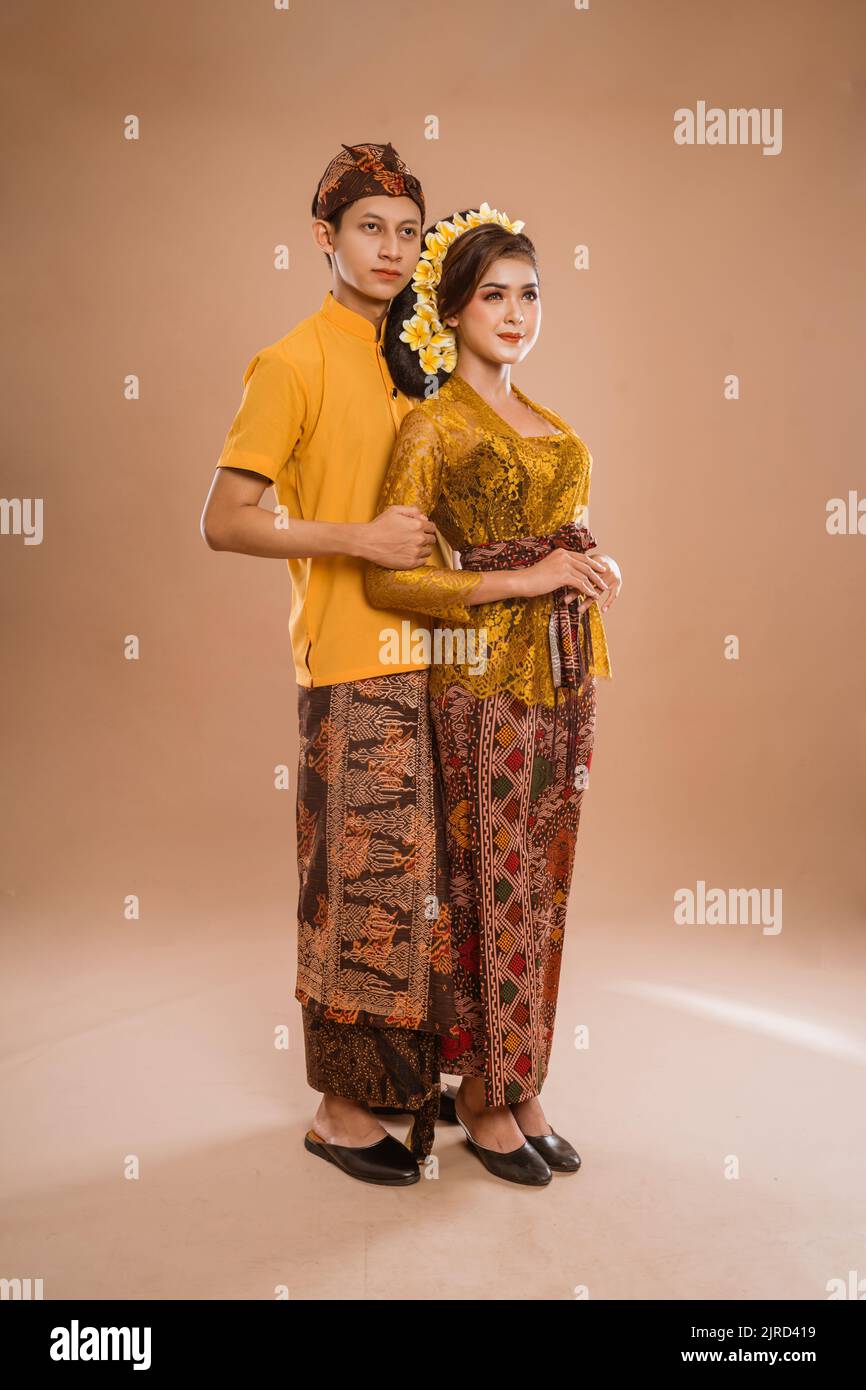 balinese couple with traditional costume over isolated background Stock Photo