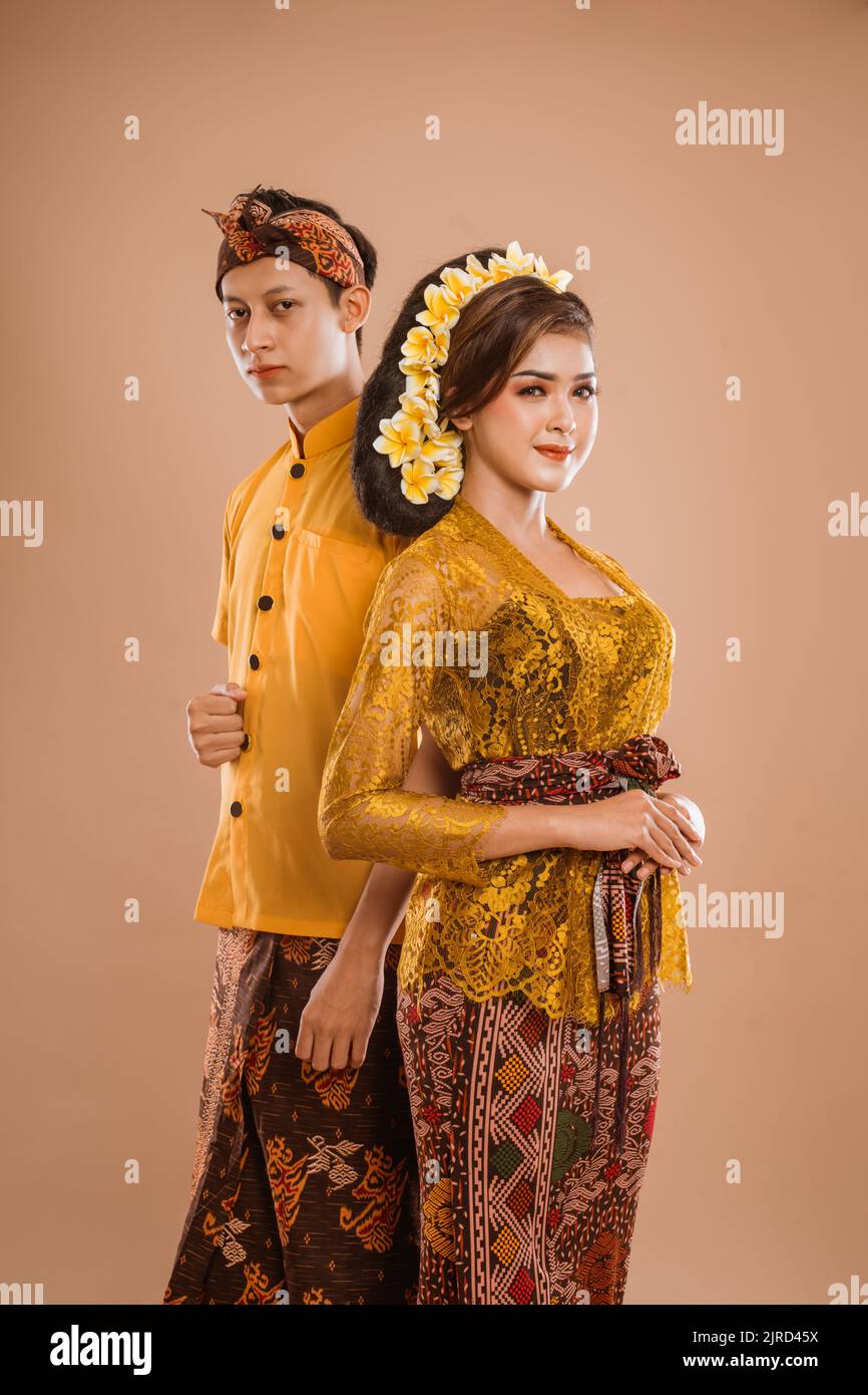 balinese couple with traditional costume over isolated background Stock Photo